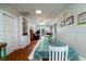 Open dining room with white table and chairs, hardwood floors at 2302 Palmetto Blvd, Edisto Beach, SC 29438