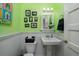 Small bathroom with pedestal sink, toilet and green walls at 2302 Palmetto Blvd, Edisto Beach, SC 29438