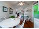 Open dining room with white table and chairs, hardwood floors at 2302 Palmetto Blvd, Edisto Beach, SC 29438