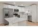 Modern kitchen featuring white cabinets, quartz countertops, and stainless steel appliances at 7049 Kenneth Dr, North Charleston, SC 29406