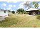 Large backyard with a covered patio, shed, and grassy lawn at 7049 Kenneth Dr, North Charleston, SC 29406
