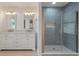 Elegant bathroom with double vanity, large mirror, and a walk-in shower at 7049 Kenneth Dr, North Charleston, SC 29406