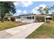 One story house with a carport and landscaped yard at 7049 Kenneth Dr, North Charleston, SC 29406