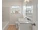 Simple bathroom with a single vanity, bathtub, and updated flooring at 7049 Kenneth Dr, North Charleston, SC 29406