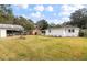 Spacious backyard with a large grassy area and storage shed at 7049 Kenneth Dr, North Charleston, SC 29406