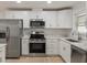 Modern kitchen with stainless steel appliances and white cabinets at 7049 Kenneth Dr, North Charleston, SC 29406