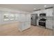 Updated kitchen with stainless steel appliances and white shaker cabinets at 7049 Kenneth Dr, North Charleston, SC 29406