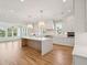 Spacious kitchen boasts white cabinets, marble island, and high-end appliances at 3881 Summerton St, Mount Pleasant, SC 29466