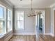 Bright dining room with hardwood floors, chandelier, and large windows at 3881 Summerton St, Mount Pleasant, SC 29466