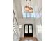 Two-story entryway with hardwood floors, staircase, and dramatic lighting at 3881 Summerton St, Mount Pleasant, SC 29466