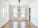 Spacious dining room with hardwood floors, wainscoting, and a modern chandelier at 3881 Summerton St, Mount Pleasant, SC 29466