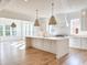 Open concept kitchen with white cabinets, large island and hardwood floors at 3881 Summerton St, Mount Pleasant, SC 29466