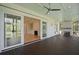 Relaxing screened porch with dark wood deck and fireplace at 3881 Summerton St, Mount Pleasant, SC 29466