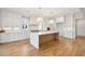 Bright kitchen features white cabinets, a large island, and hardwood floors at 3881 Summerton St, Mount Pleasant, SC 29466