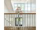 Elegant staircase with wood railing and unique light fixtures at 3881 Summerton St, Mount Pleasant, SC 29466