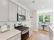 Bright kitchen features gas range, microwave, and white subway tile backsplash at 426 Queenview Ln, Charleston, SC 29414