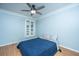 Blue bedroom with a queen bed, wood floors, and a ceiling fan at 101 Westmoreland St, Summerville, SC 29483