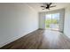 Spacious bedroom with hardwood floors and private balcony access at 2216 Clinton St, North Charleston, SC 29405