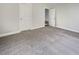 Well-lit bedroom featuring neutral walls, plush carpeting, and two doors at 209 Turner Greens Ct, Goose Creek, SC 29445