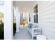 Relaxing front porch with white bench and pillows at 123 Cantona Dr, Summerville, SC 29483