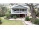 Charming two-story home with a spacious deck and landscaped yard at 1225 Tabby Dr, Folly Beach, SC 29439