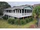 Elevated beach home with large deck and lush landscaping at 1225 Tabby Dr, Folly Beach, SC 29439