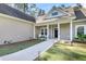 Inviting front porch with landscaping at 5829 Yellow Dog Rd, Ravenel, SC 29470