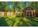 Large backyard with wooden shed and green lawn at 154 Pecan Dr, Summerville, SC 29483