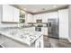 Modern kitchen with white cabinets, granite counters, and stainless steel appliances at 154 Pecan Dr, Summerville, SC 29483