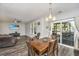 Bright dining area with wood table and chairs, near kitchen and sliding doors at 154 Pecan Dr, Summerville, SC 29483