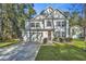 Two-story home with white siding, a gray door, and a two-car garage at 154 Pecan Dr, Summerville, SC 29483