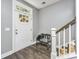 Inviting entryway with white door, wood floors, and charming bench at 154 Pecan Dr, Summerville, SC 29483