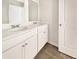 Double vanity bathroom with neutral colors and wood-look flooring at 498 Lake Ridge Blvd, Summerville, SC 29486