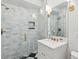 Elegant bathroom with marble tile shower, white vanity, and gold fixtures at 74 Vanderhorst St, Charleston, SC 29403