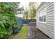 Landscaped backyard with brick patio and wooden dining set at 74 Vanderhorst St, Charleston, SC 29403