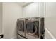 Laundry room with modern washer and dryer, and overhead cabinets at 8586 Refuge Point Cir, North Charleston, SC 29420