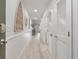 Bright hallway with white shiplap walls and light wood floors at 1331 Pelican Watch Villas, Seabrook Island, SC 29455