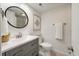 Small bathroom with gray vanity, white toilet and walk-in shower at 1331 Pelican Watch Villas, Seabrook Island, SC 29455