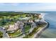 Aerial view of a coastal community with golf course, pools, and oceanfront access at 1331 Pelican Watch Villas, Seabrook Island, SC 29455
