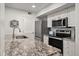Kitchen boasts granite countertops and stainless steel appliances at 1331 Pelican Watch Villas, Seabrook Island, SC 29455