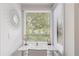White vanity with mirror and window views at 1331 Pelican Watch Villas, Seabrook Island, SC 29455