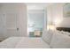 Bedroom with king bed, white bedding, and window seat at 1331 Pelican Watch Villas, Seabrook Island, SC 29455