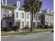 Row of three-story townhouses in brick and white, with palm trees at 752 Certificate Ct, Charleston, SC 29414