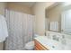 Simple bathroom with a neutral shower curtain and wood cabinets at 4966 Ballantine Drive, Summerville, SC 29485