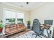 Functional home office with leather couch, large desk, and ample natural light at 4966 Ballantine Drive, Summerville, SC 29485