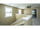 Upstairs hallway with a half wall and view to a bedroom at 4966 Ballantine Drive, Summerville, SC 29485