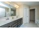 Double vanity bathroom with dark wood cabinets and a large mirror at 4966 Ballantine Drive, Summerville, SC 29485