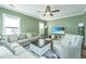 Spacious living room with hardwood floors, sectional sofa, and large TV at 4966 Ballantine Drive, Summerville, SC 29485