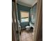 Small bathroom with tiled floor, toilet, and vanity; needs some updating at 204 Charles St, Saint George, SC 29477
