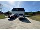 Detached garage with two cars parked in the driveway at 204 Charles St, Saint George, SC 29477